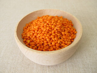 Red lentils in a wooden bowl