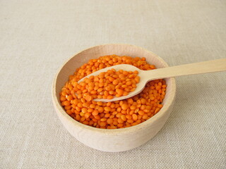 Red lentils in a wooden bowl