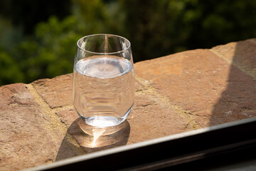 Glass of water for the refreshment on the windowsill on a hot summer day in Italy. Toscana, Italia