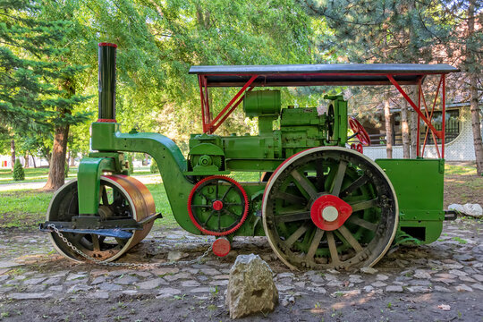 Old steamroller in red and green color. Antique Steamroller