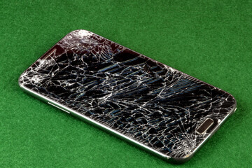 Shattered Smart Phone on a Green Felt Table Top - 440422127