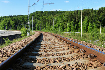 Fototapeta na wymiar Railway tracks and beautiful mountain landscapes all around.