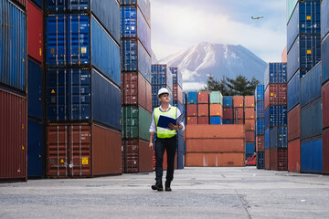 Foreman holding document, walking and checking the containers box from cargo ship for export and...