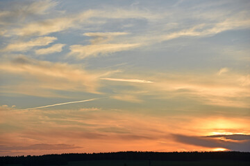 Sunset horizon with sun and clouds in the evening