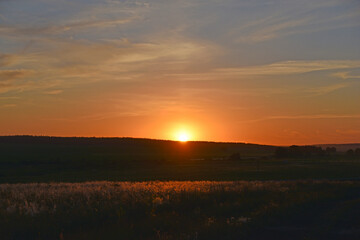 Sunset horizon with sun and clouds in the evening