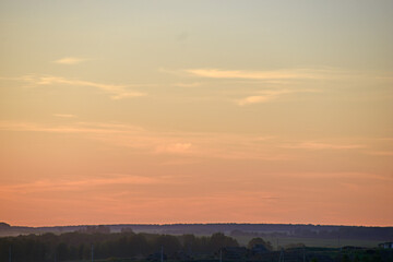 Rural field on the background of the setting sun