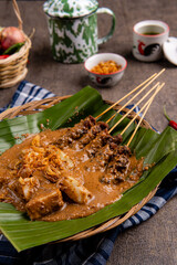 Pork Satay or Sate Babi. Pork Satay served with a Peanut sauce and slices of lontong or ketupat (rice cakes)