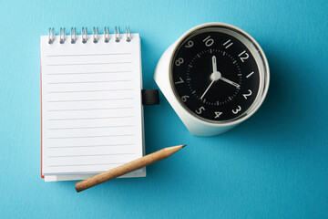 blank lined note book  and alarm clock for copy space time to act