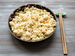 chinese cuisine - yangzhou fried rice in ceramic plate on wooden table