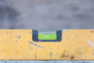Yellow spirit level old on wood table