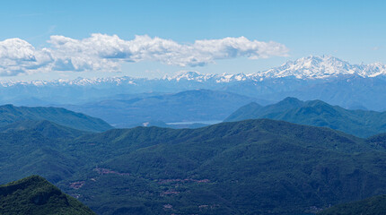 Obraz premium layers of mountains, view from Monte Generoso to the Swiss with snow on the top in summer