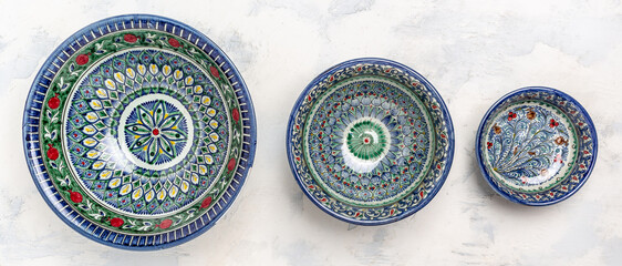 blue ceramics dish with white floral ornament in Central Asian style. Ethnic Uzbek ceramics dishes,...