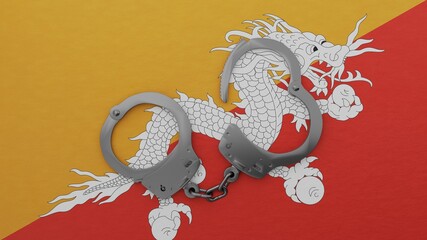 A half opened steel handcuff in center on top of the national flag of Bhutan