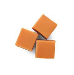 Heap of caramel candies on white background, top view