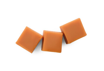 Heap of caramel candies on white background, top view