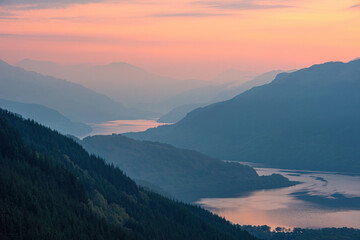 Sunrise over a misty Loch Lomond in the Scottish Highlands