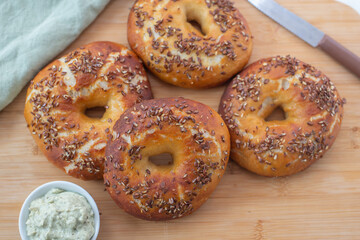 Freshly baked whole grain bagels. heap of fresh baked bagels on a table