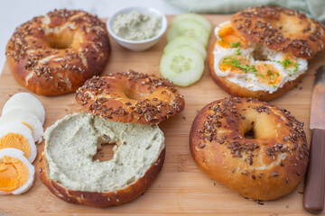 Freshly baked whole grain bagels. heap of fresh baked bagels on a table