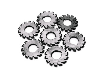 Several metal milling disc cutters for industrial equipment. The tool is isolated on a white background. Close-up