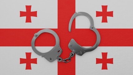 A half opened steel handcuff in center on top of the national flag of Georgia