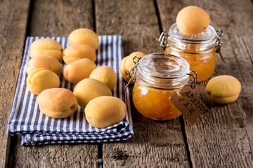 Homemade Organic Jam in Glass Jasr and Ripe Apricots on Wooden Rustic Background Horizontal