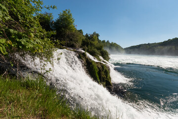 Fototapeta na wymiar Splashing water at the incredible rhine falls in Switzerland 28.5.2021