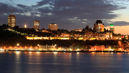 Fototapeta na wymiar Quebec City skyline at dusk with Saint Lawrence River on the foreground