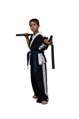 Obraz premium 8 year old boy wearing a black martial arts kimono doing martial arts poses on a white background.