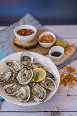 Oysters ,Yum, Oyster and side dishes in Thai style with spicy dipping sauce.