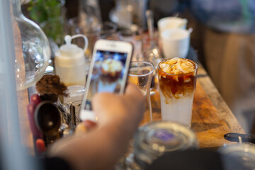 Coconut meat in a coffee cup mixed with coconut water on the coffee table in a coffee shop in Thailand A refreshing cold drink with aromas of coffee and coconut.