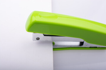 Closeup shot of a green stapler on a white background