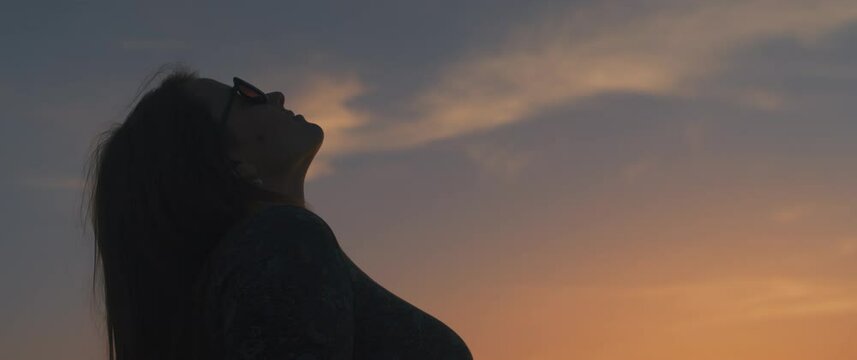 A Young Woman Throwing Her Head Back, Breathing The Summer Air At Sunset. Slow Motion, Handheld, Medium Shot. 