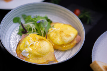 eggs benedict delicious breakfast on black background