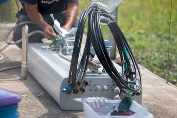 The new transmitter, mobile phone, antenna placed on the ground are being swapped with the old one. Switching from 4g network to 5g