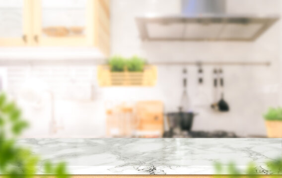 White marble texture table top on blurred kitchen background for montage or display your products.
