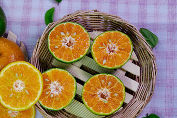 cut of half orange on a wooden plate