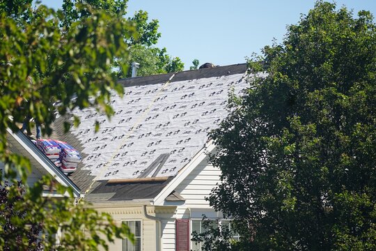 "West Chester, PA USA - 5 10 2021: Installing new roof or fixing reparing old roof top of town home