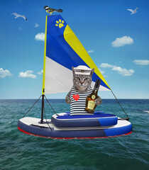 A gray cat sailor with a bottle of rum sits in a inflatable sailing dinghy on the sea.