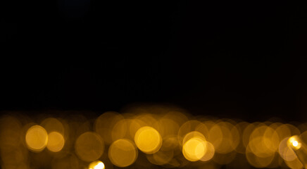 golden shining lights on black background. Decoration or christmas background. Copy space