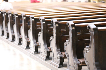 Pews in rows in the church with people sitting in them