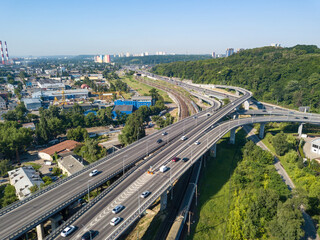 Fototapeta na wymiar Darnitsky bridge in Kiev in sunny weather. Aerial drone view.