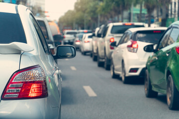 Transportation of white car on the road. Open light break waiting to release traffic signals. On the asphalt road. Many cars prepare to travel or business time. Environment in the main city.
