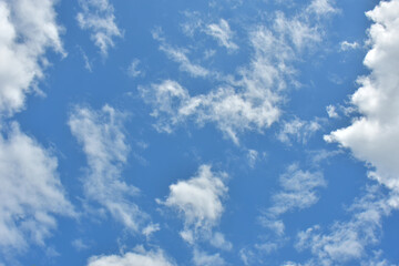 Beautiful cumulus clouds against the blue daytime sky.