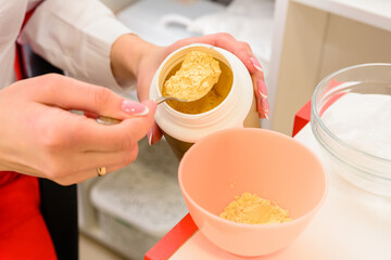 Preparation of a golden mask, a procedure at a beautician, facial care.