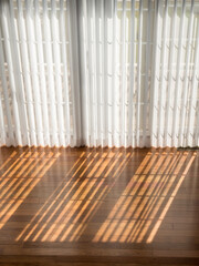 Vertical blinds cast shadows on a newly installed Brazilian Cherry hardwood floor