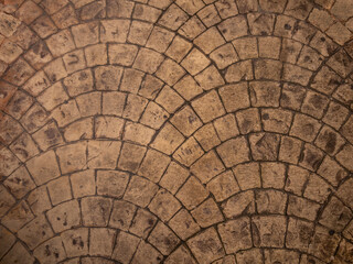 Background stone mosaic texture. Paving slabs of brown shades laid in the form of fans.