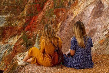 two young woman with dresses enjoying a break in a lake in Riotinto, huelva, Spain