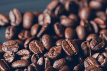 Fresh roasted coffee beans background, Dark tone, Selective focus.