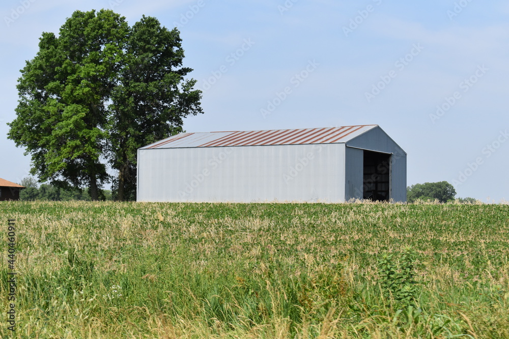 Sticker metal barn in a field