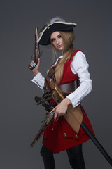 Side view studio shot of woman pirate with pistol